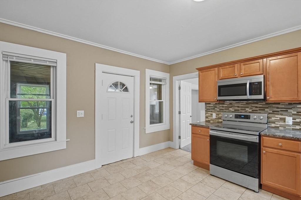 941 Allen Street Springfield, MA 01118 - Photo 5 of 28 a kitchen with stainless steel appliances granite countertop a stove and a refrigerator