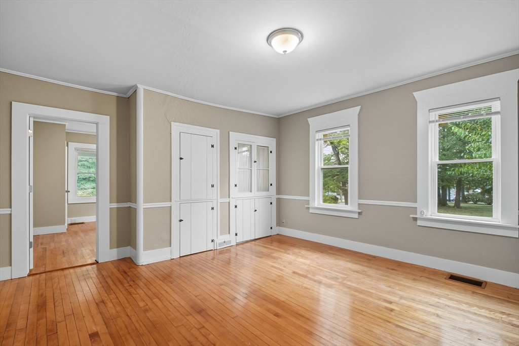 941 Allen Street Springfield, MA 01118 - Photo 8 of 28 an empty room with wooden floor and windows
