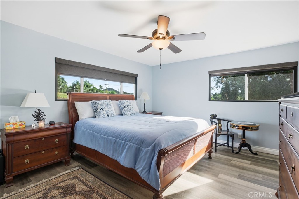 14010 Hilldale Road Valley Center, CA 92082 - Photo 17 of 28 a bedroom with a bed and a chandelier