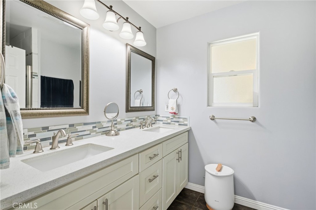14010 Hilldale Road Valley Center, CA 92082 - Photo 19 of 28 a bathroom with a double vanity sink toilet and mirror