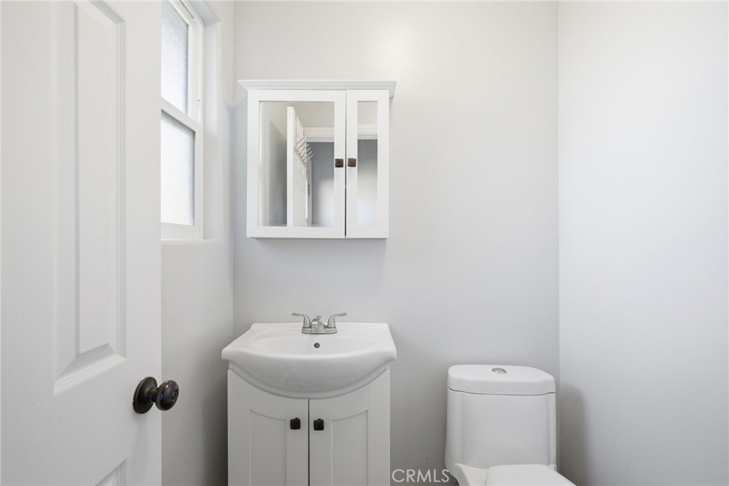 14010 Hilldale Road Valley Center, CA 92082 - Photo 22 of 28 a bathroom with a toilet sink and mirror