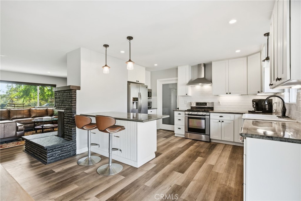 14010 Hilldale Road Valley Center, CA 92082 - Photo 4 of 28 a kitchen with white cabinets and appliances