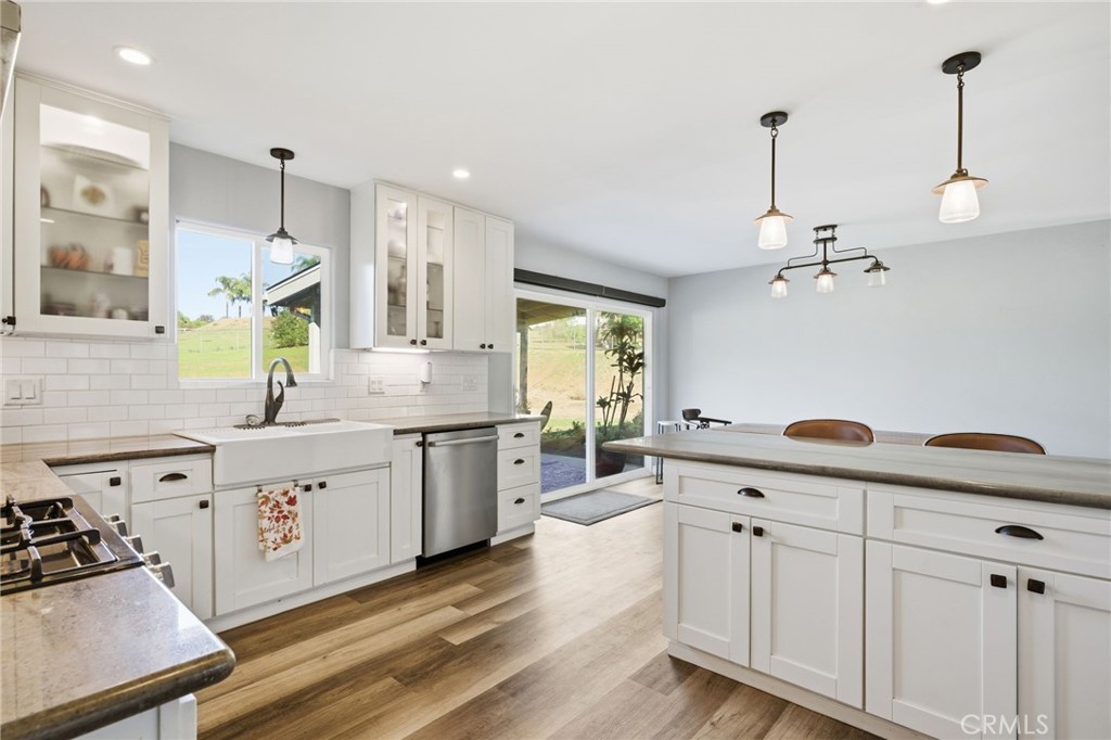 14010 Hilldale Road Valley Center, CA 92082 - Photo 7 of 28 a large kitchen with a lot of counter space and wooden floor