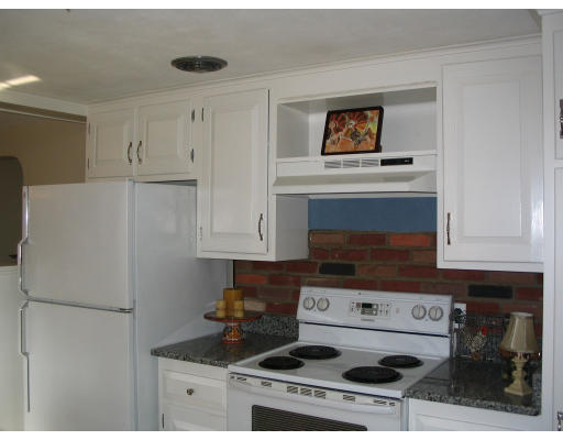107 Newton Road Springfield, MA 01118 - Photo 3 of 17 a stove top oven sitting inside of a kitchen