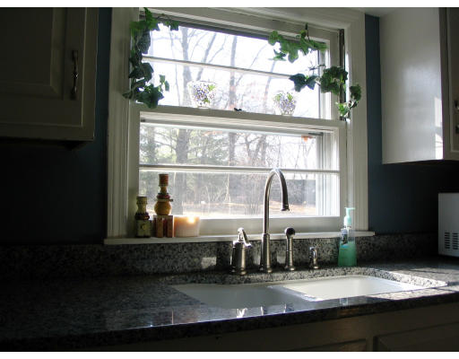 107 Newton Road Springfield, MA 01118 - Photo 4 of 17 a kitchen with a stove a faucet and a dining table