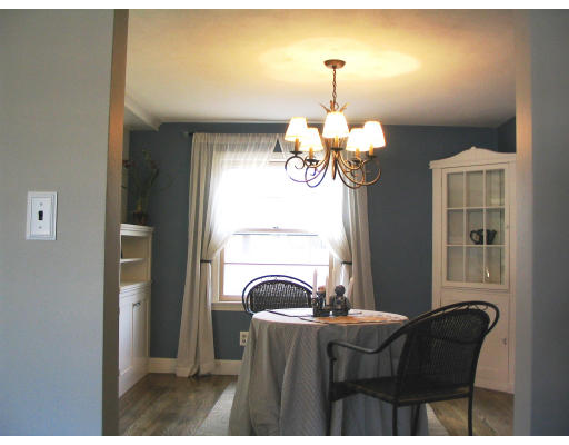 107 Newton Road Springfield, MA 01118 - Photo 10 of 17 a view of a dining room with furniture wooden floor and chandelier