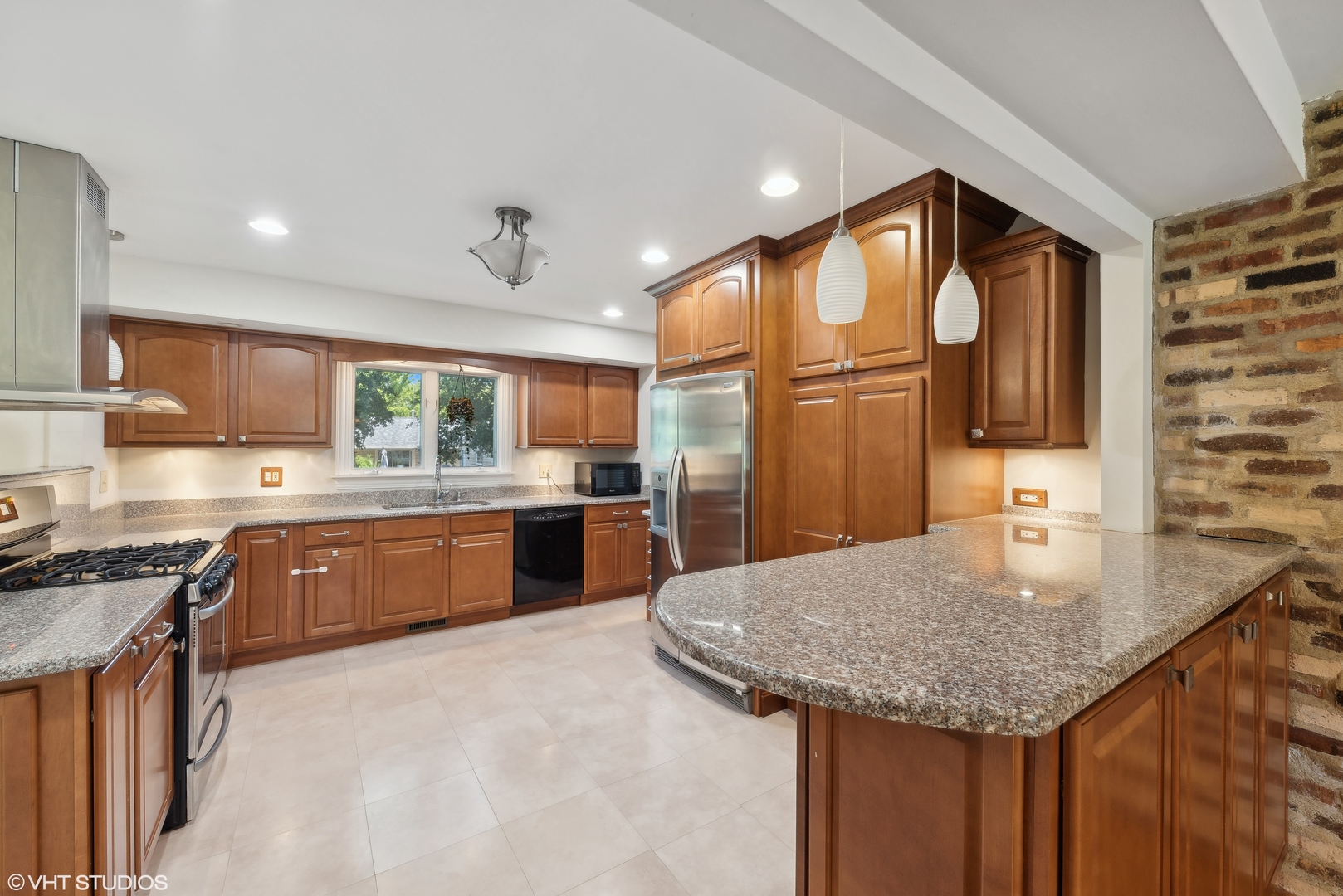 521 North Rohlwing Road Palatine, IL 60074 - Photo 5 of 19 a kitchen with stainless steel appliances granite countertop a sink refrigerator and cabinets