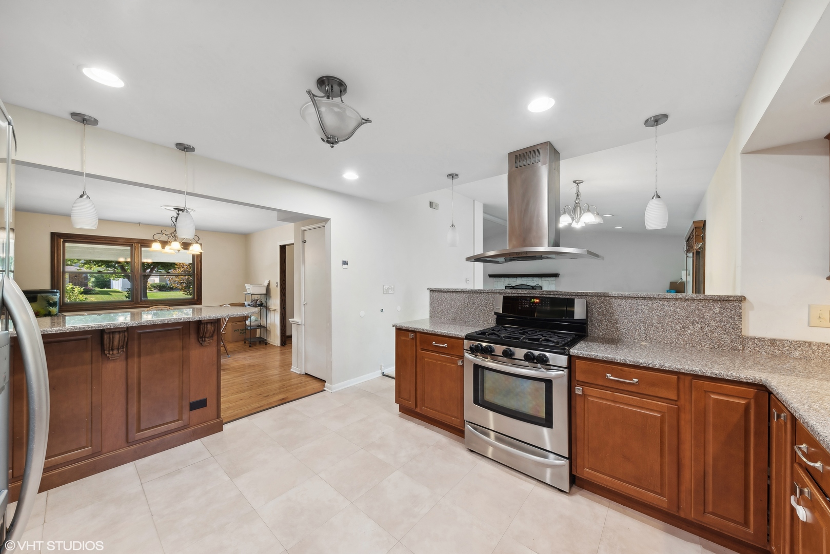 521 North Rohlwing Road Palatine, IL 60074 - Photo 6 of 19 a kitchen with stainless steel appliances granite countertop a stove and a sink