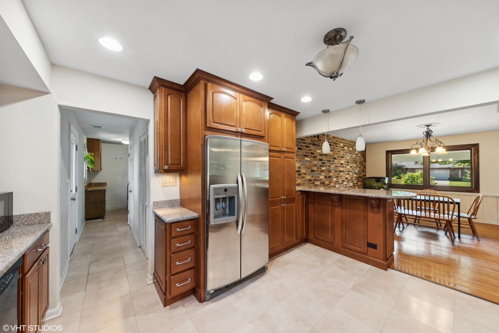521 North Rohlwing Road Palatine, IL 60074 - Photo 7 of 19 a kitchen with stainless steel appliances kitchen island granite countertop a refrigerator and stove