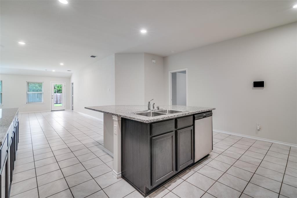 2235 Vance Drive Forney, TX 75126 - Photo 11 of 40 View of the kitchen from the fridge area.