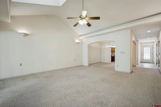a view of an empty room with a ceiling fan