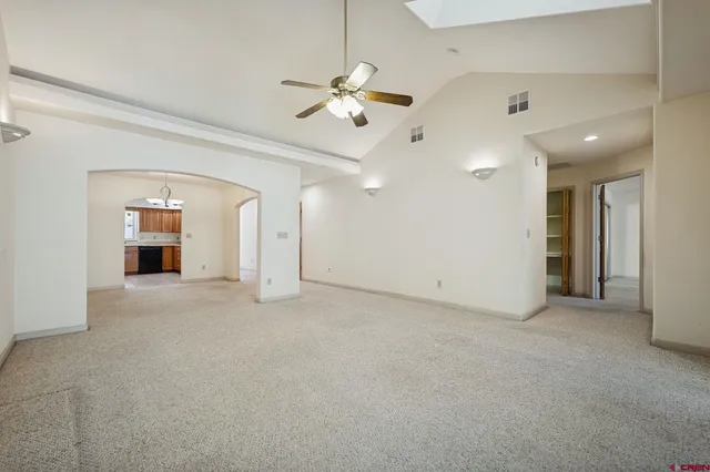 a view of a livingroom with a ceiling fan and window