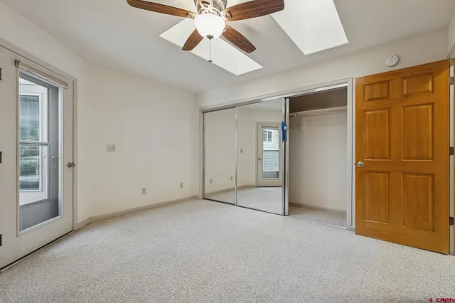 an empty room with chandelier fan