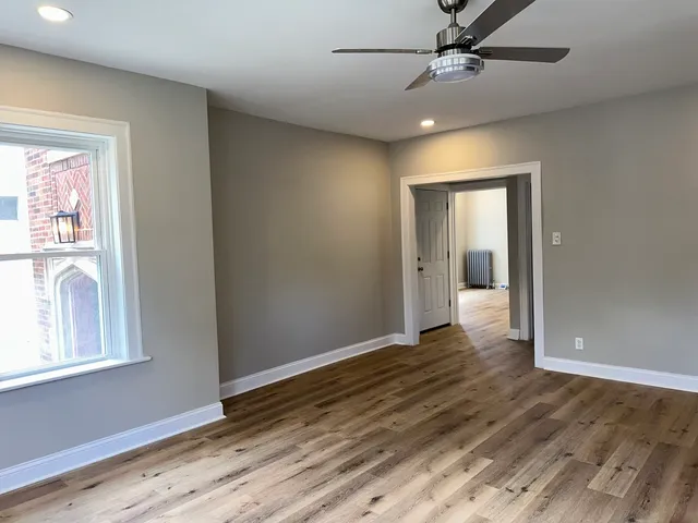wooden floor in an empty room with a window