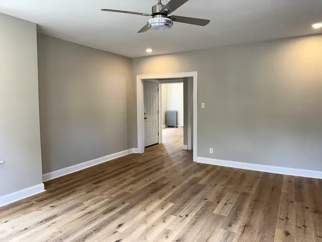 wooden floor in an empty room with a window