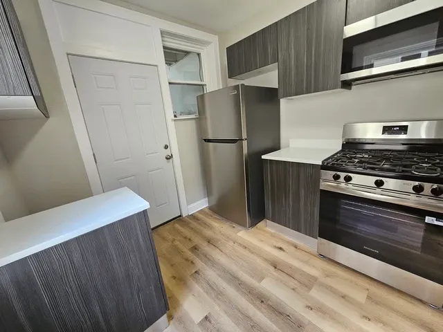 a kitchen with a stove and a refrigerator