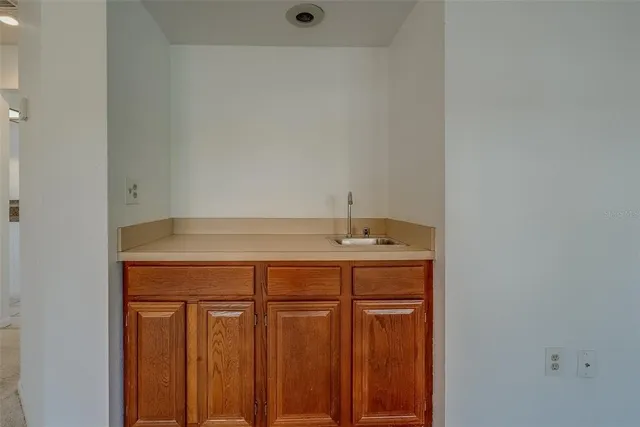 a kitchen with a sink stove and refrigerator