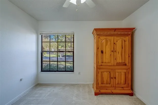 a view of a room with wooden floor and iron stairs