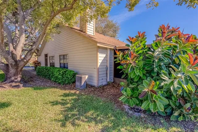an aerial view of lake residential house with swimming pool and lawn chairs
