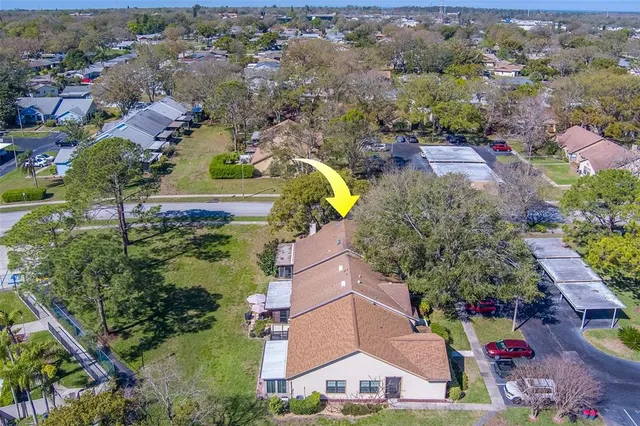 an aerial view of a house with yard