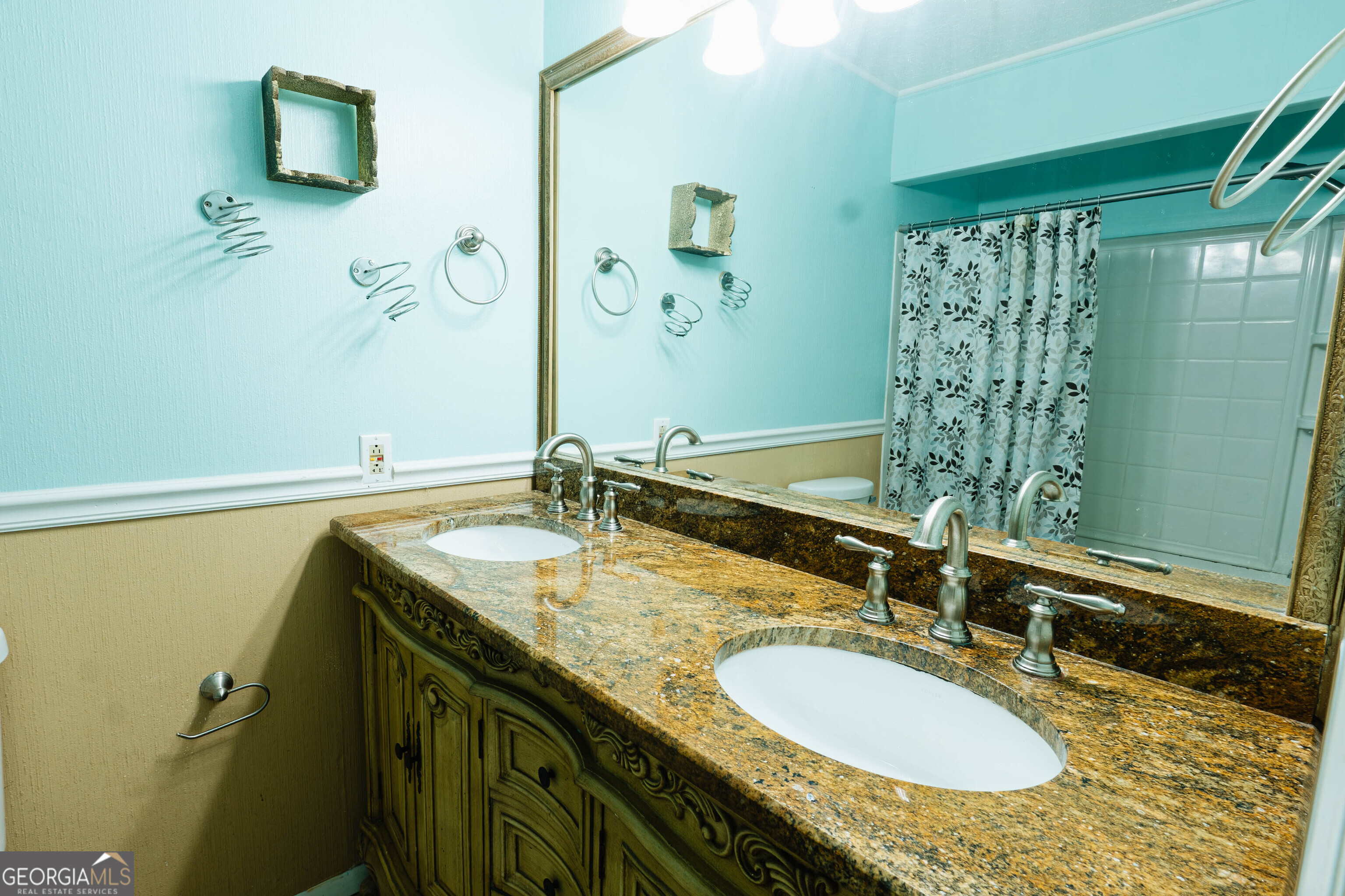 139 Cords Bridge Road Northeast Milledgeville, GA 31061 - Photo 17 of 35 a bathroom with a granite countertop sink and a mirror