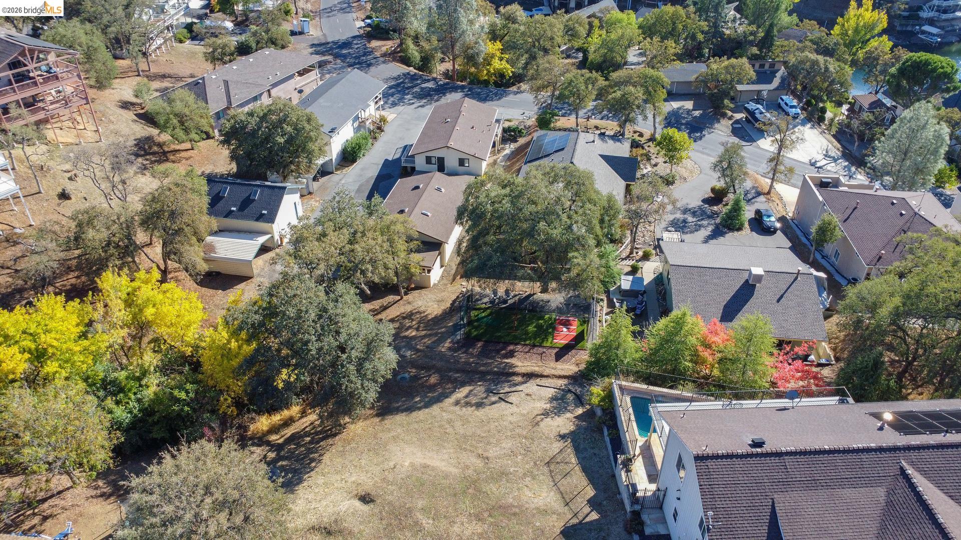 501 Indian Hill Road Copperopolis, CA 95228 - Photo 4 of 10 Aerial perspective of a neighborhood setting with mature trees and varied architectural styles