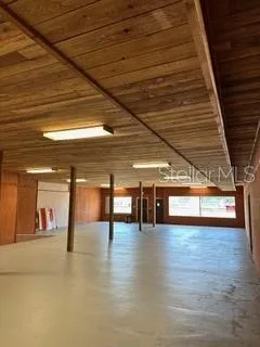 a view of a hall with wooden floor