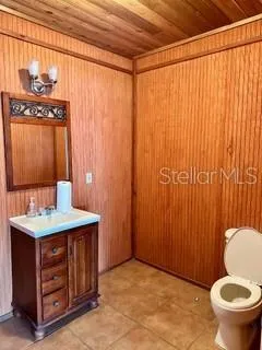 a bathroom with a sink a toilet and shower curtain