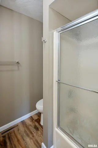 a bathroom with a glass shower door