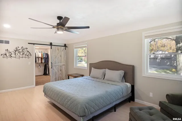 a bedroom with a large bed and a window