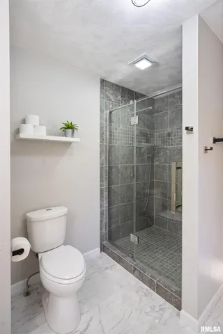 a bathroom with a toilet and shower