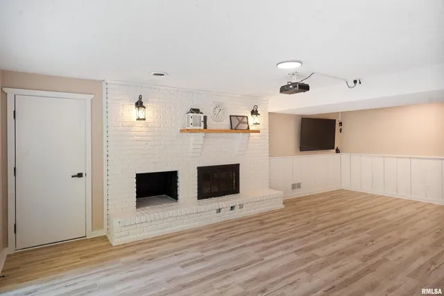 a view of a livingroom with an empty space and a fireplace