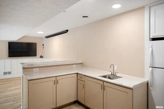 a kitchen with a sink and white cabinets