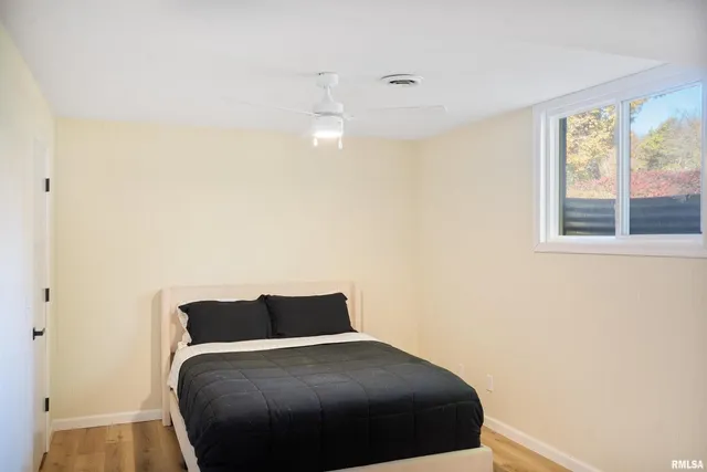 a bedroom with a bed and window