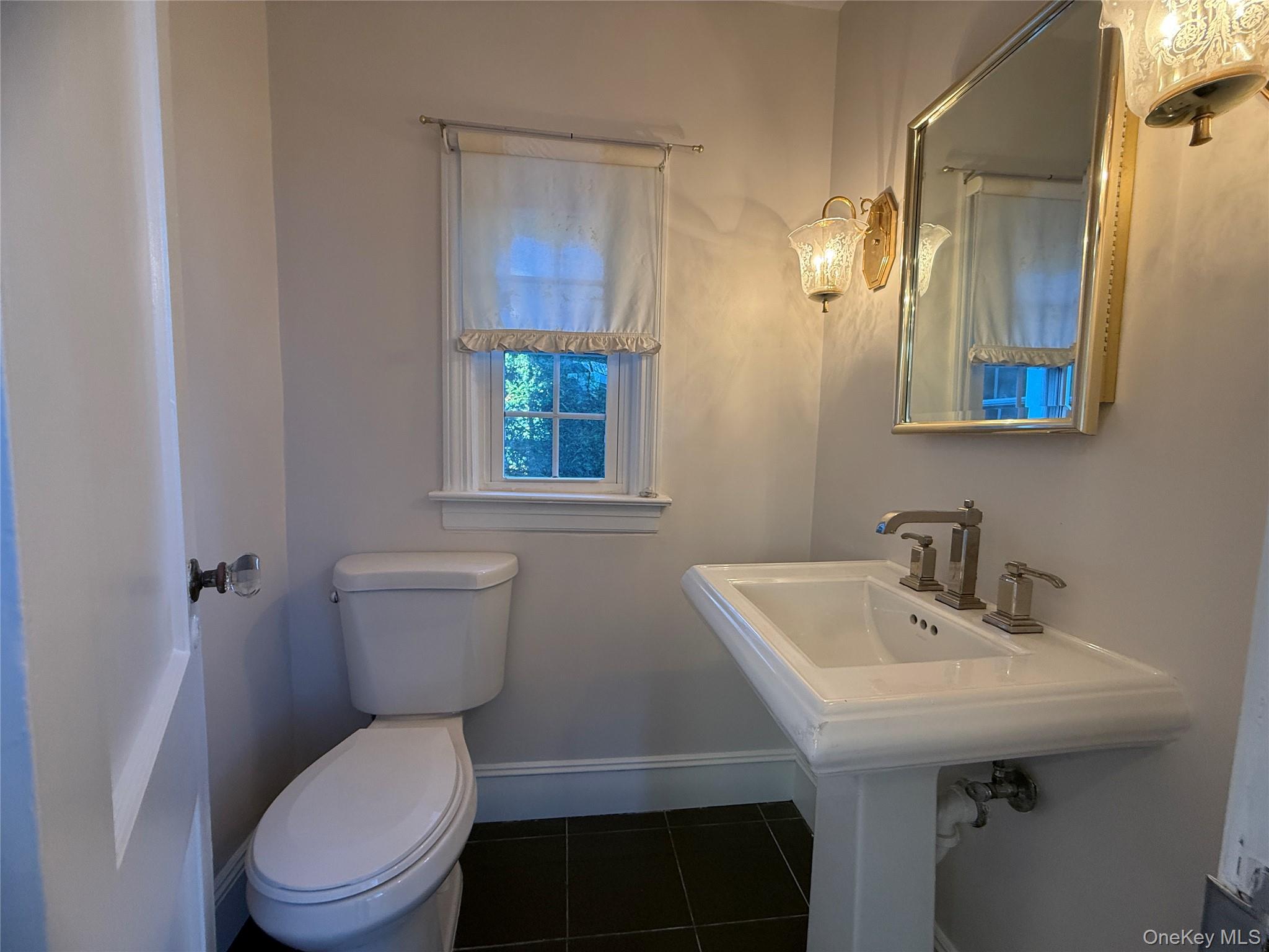 71 Hillcrest Avenue Manhasset, NY 11030 - Photo 12 of 23 a bathroom with a sink a toilet and mirror