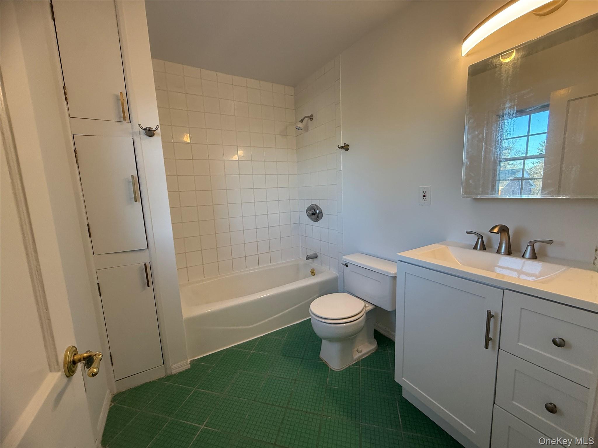 71 Hillcrest Avenue Manhasset, NY 11030 - Photo 19 of 23 a bathroom with a sink toilet and shower