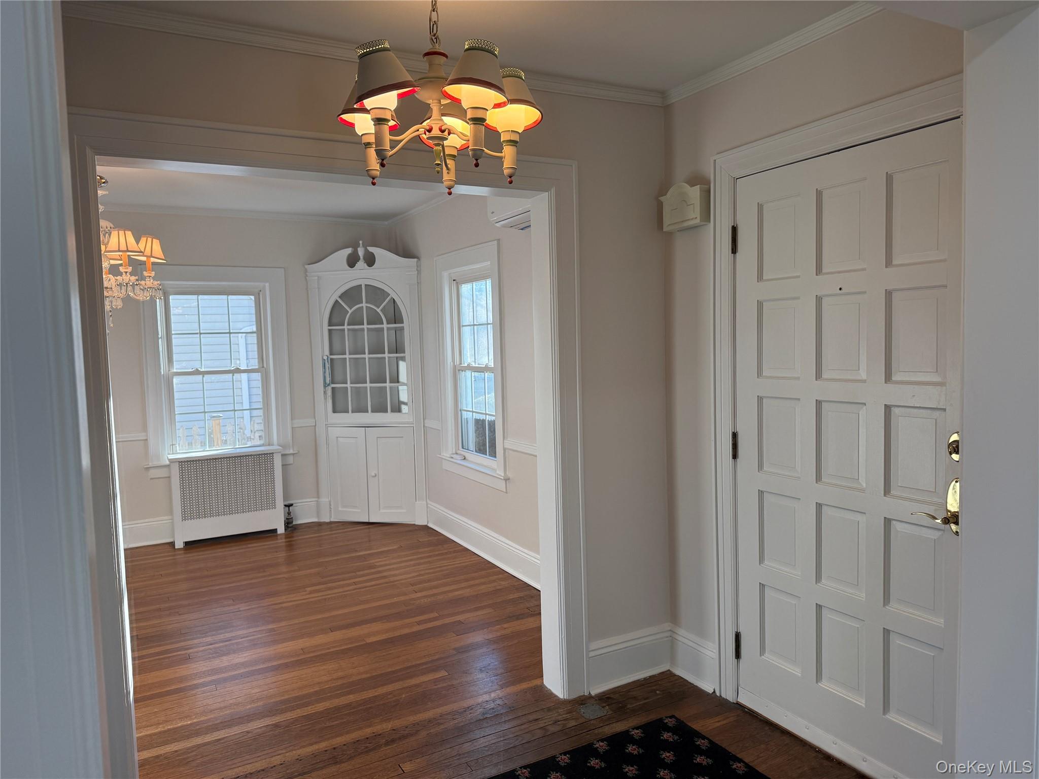 71 Hillcrest Avenue Manhasset, NY 11030 - Photo 3 of 23 wooden floor in an empty room with a window