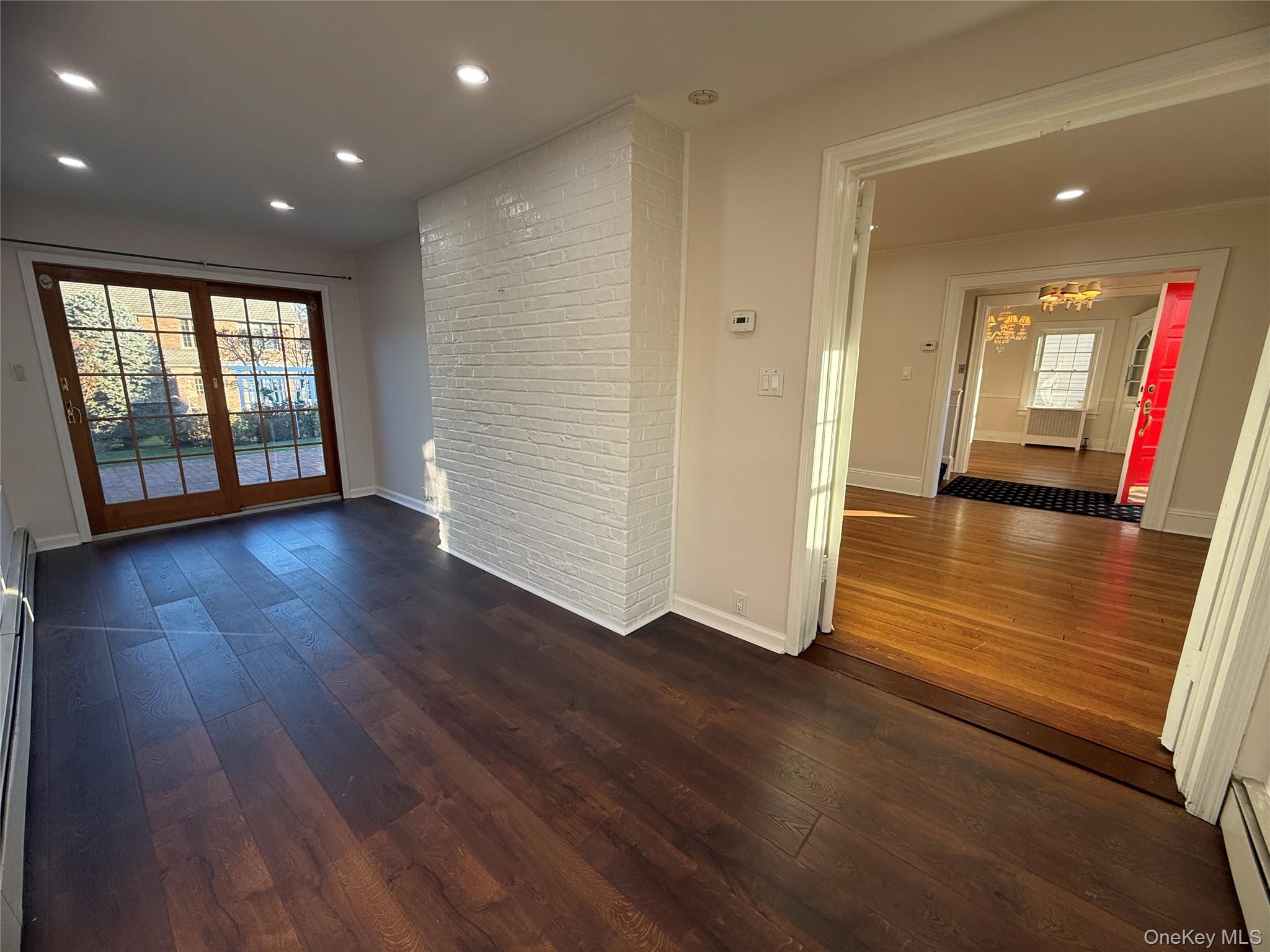71 Hillcrest Avenue Manhasset, NY 11030 - Photo 7 of 23 an empty room with wooden floor and windows