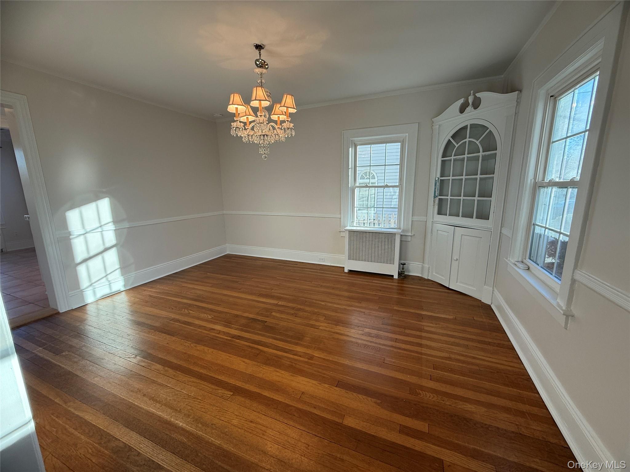 71 Hillcrest Avenue Manhasset, NY 11030 - Photo 8 of 23 wooden floor in an empty room with a window