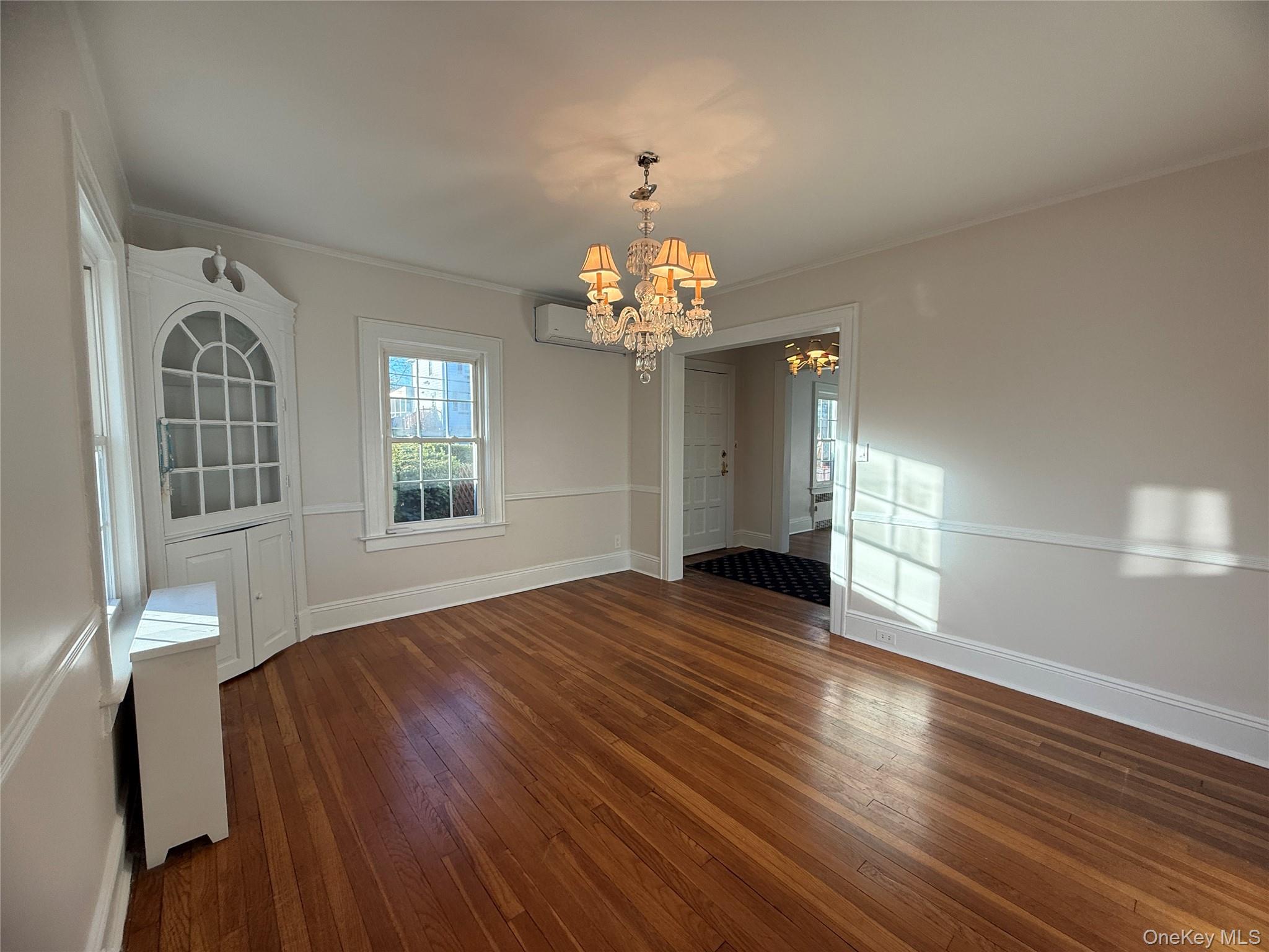 71 Hillcrest Avenue Manhasset, NY 11030 - Photo 9 of 23 a view of livingroom with wooden floor and chandelier