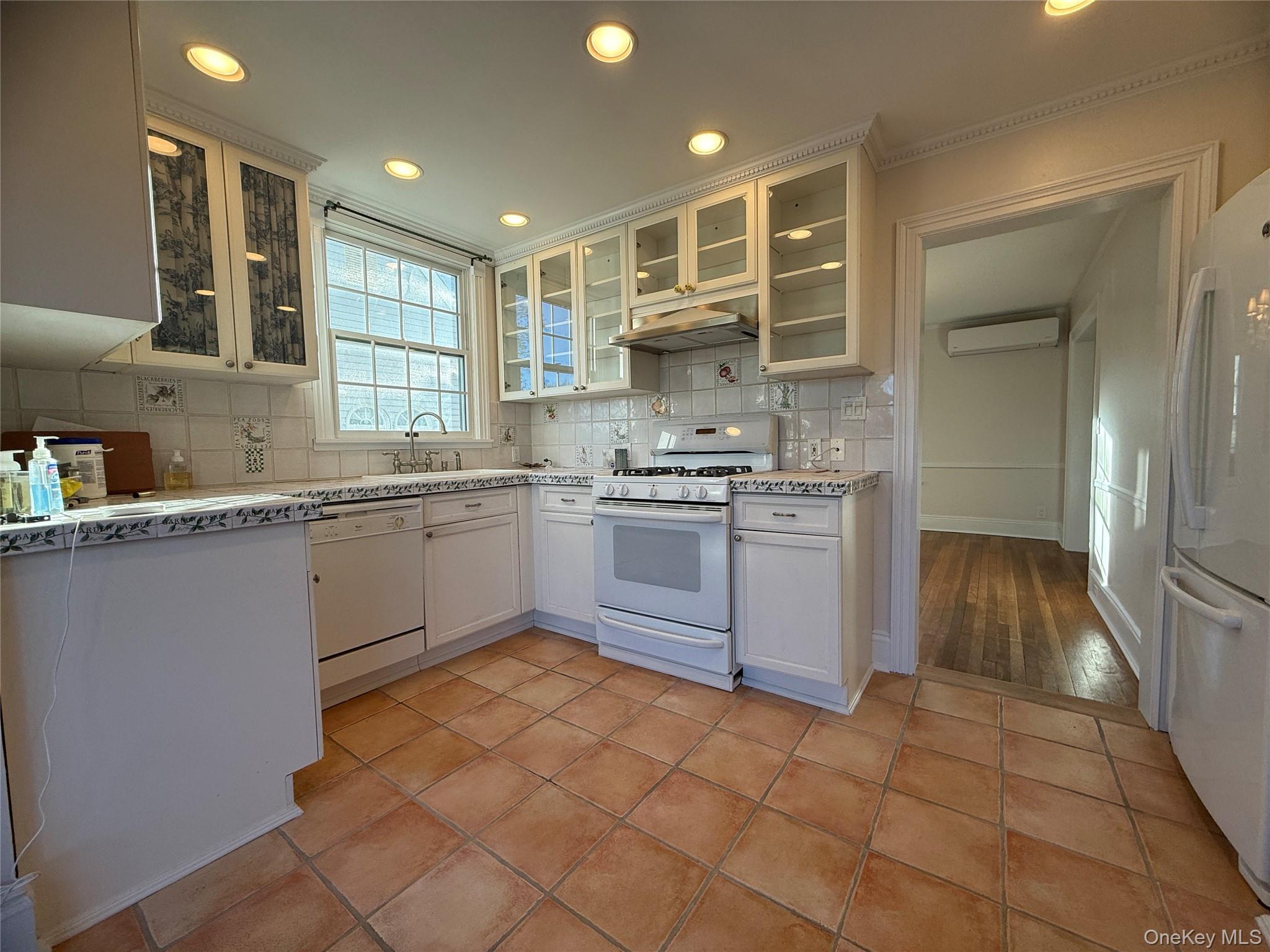 71 Hillcrest Avenue Manhasset, NY 11030 - Photo 10 of 23 a kitchen with a stove sink and cabinets