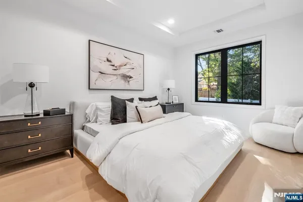 a bedroom with a bed and a large window