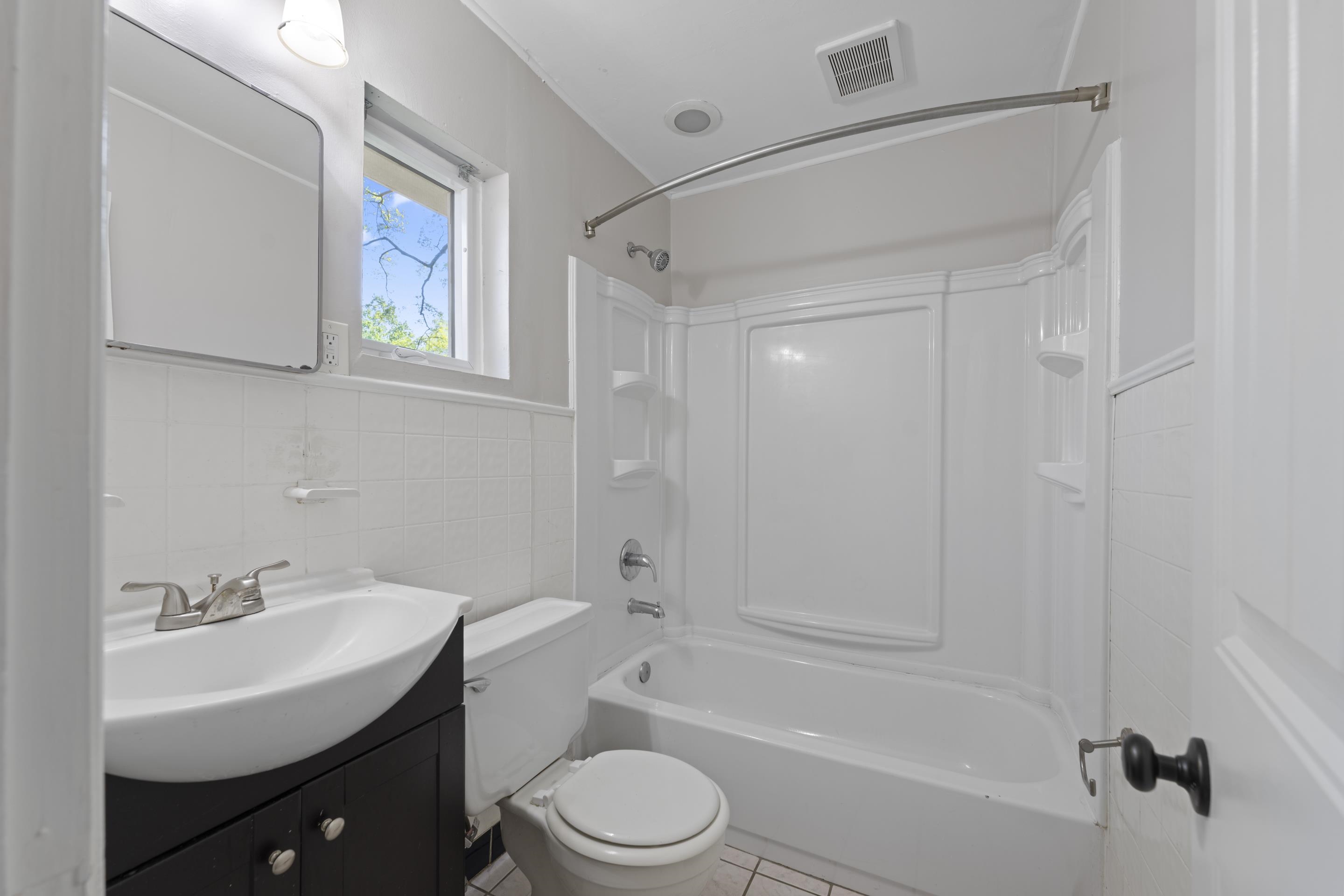 1603 Colonial Road Memphis, TN 38117 - Photo 12 of 24 a bathroom with a sink toilet a mirror and shower