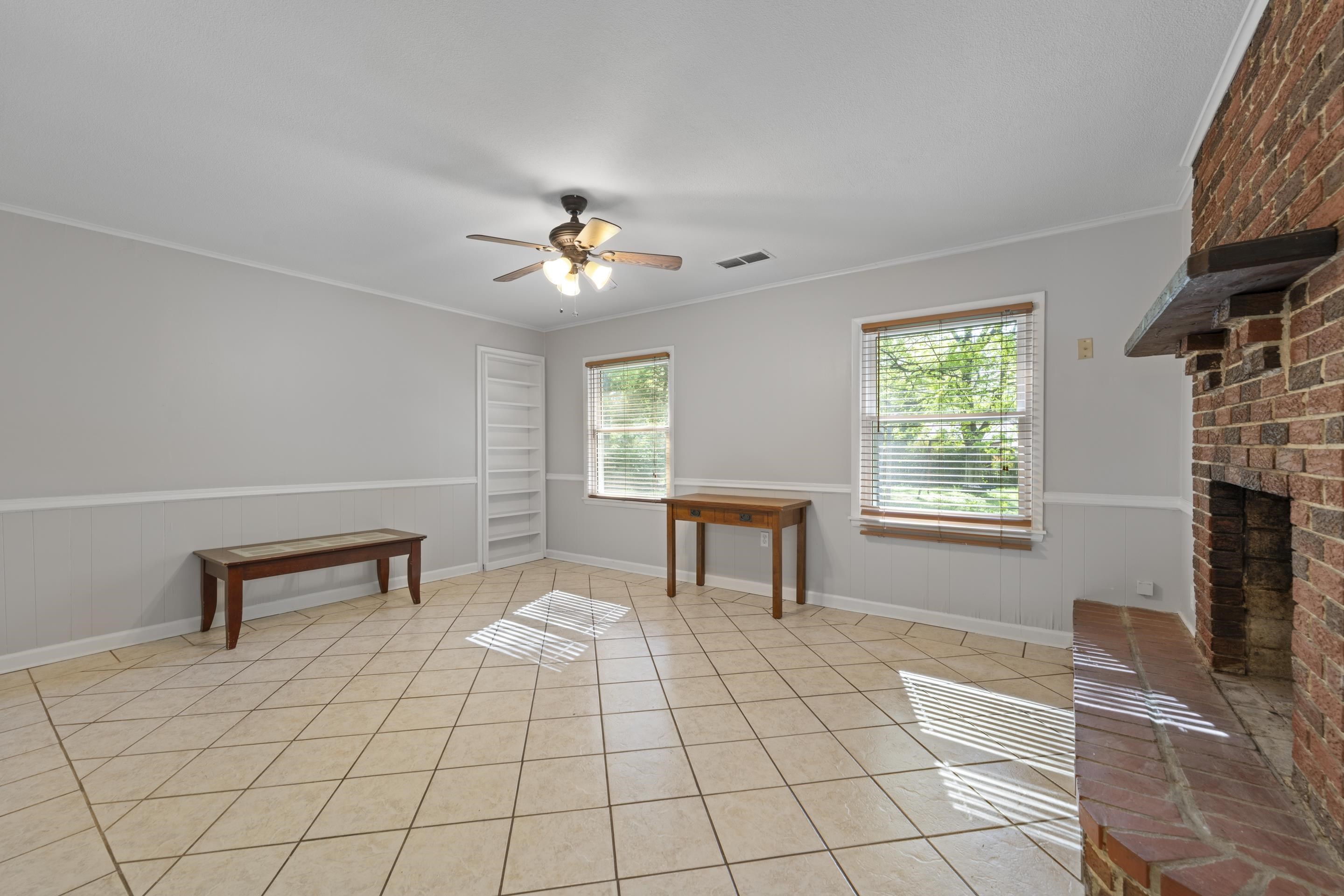 1603 Colonial Road Memphis, TN 38117 - Photo 18 of 24 a view of an empty room with a window and a fireplace