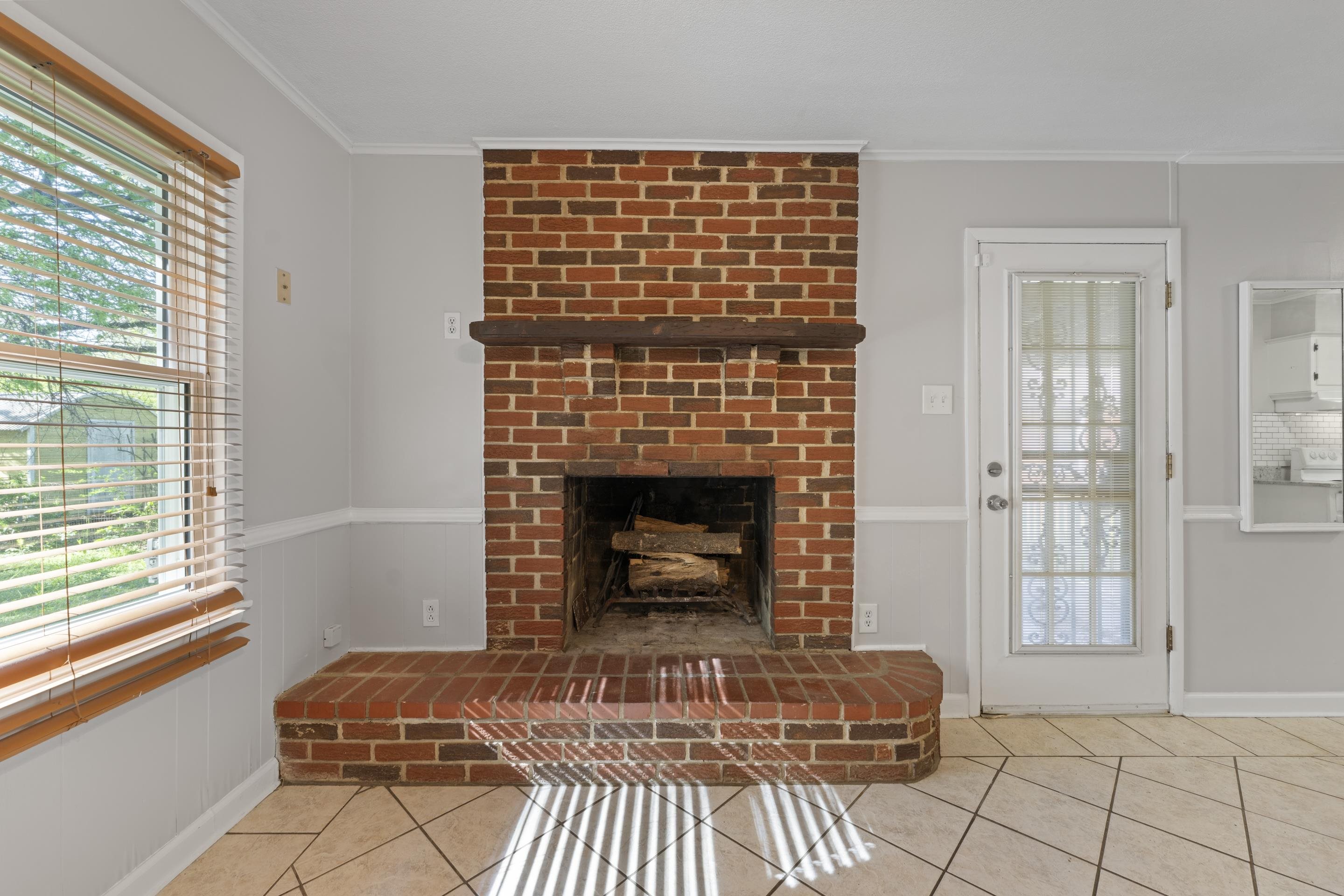 1603 Colonial Road Memphis, TN 38117 - Photo 19 of 24 a living room with furniture a window and a fireplace