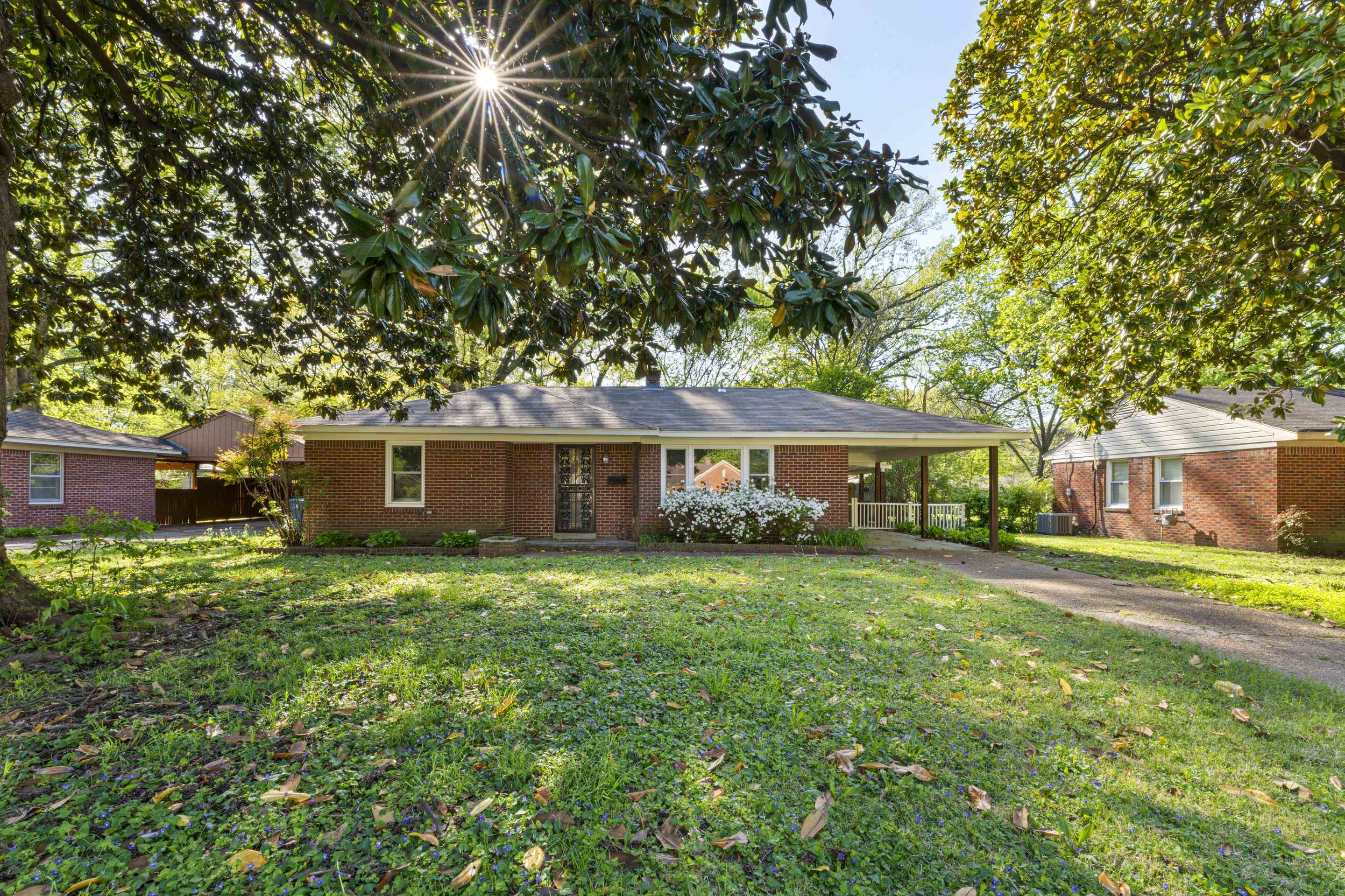 1603 Colonial Road Memphis, TN 38117 - Photo 2 of 24 a front view of a house with a garden