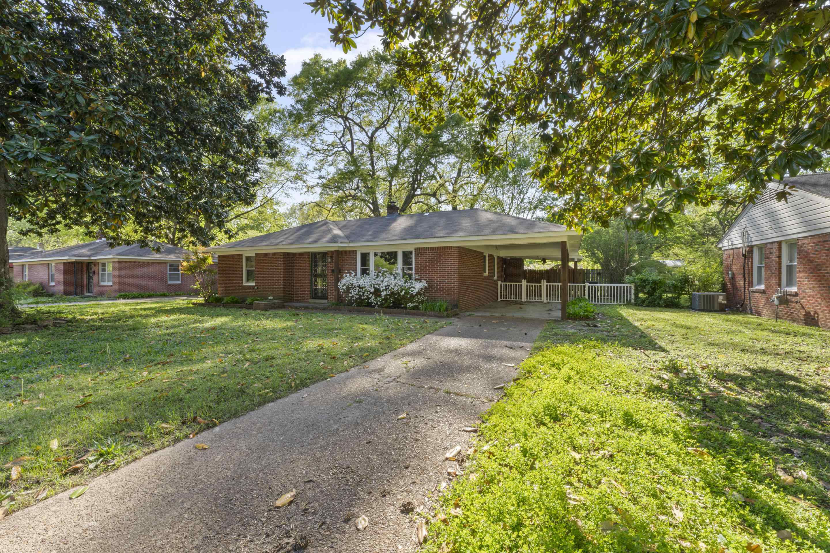 1603 Colonial Road Memphis, TN 38117 - Photo 24 of 24 a front view of a house with a yard and trees