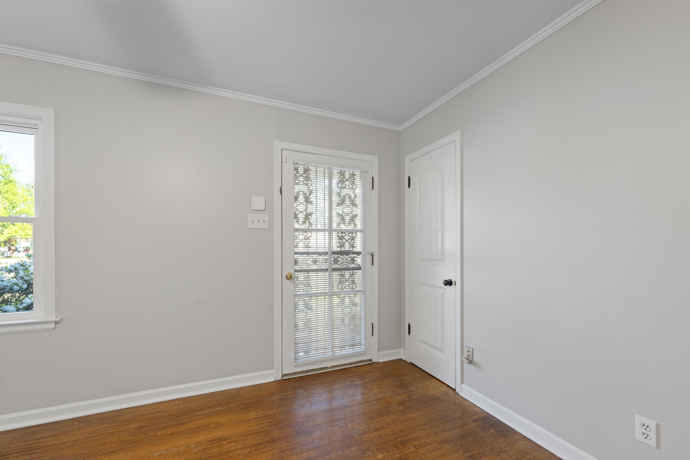 1603 Colonial Road Memphis, TN 38117 - Photo 5 of 24 an empty room with wooden floor and windows