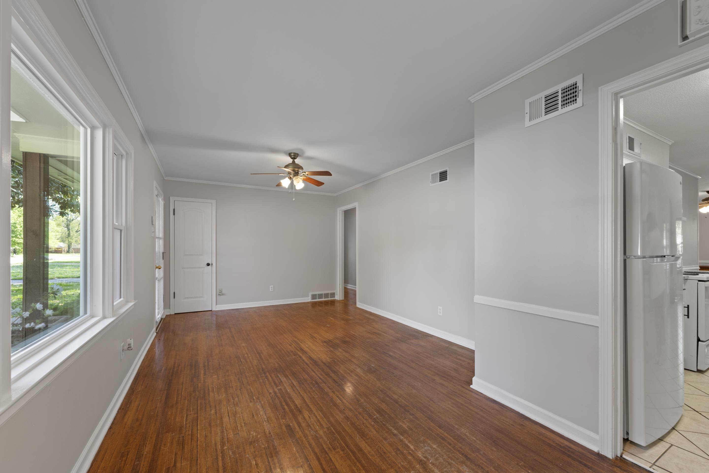 1603 Colonial Road Memphis, TN 38117 - Photo 7 of 24 a view of empty room with wooden floor and fan