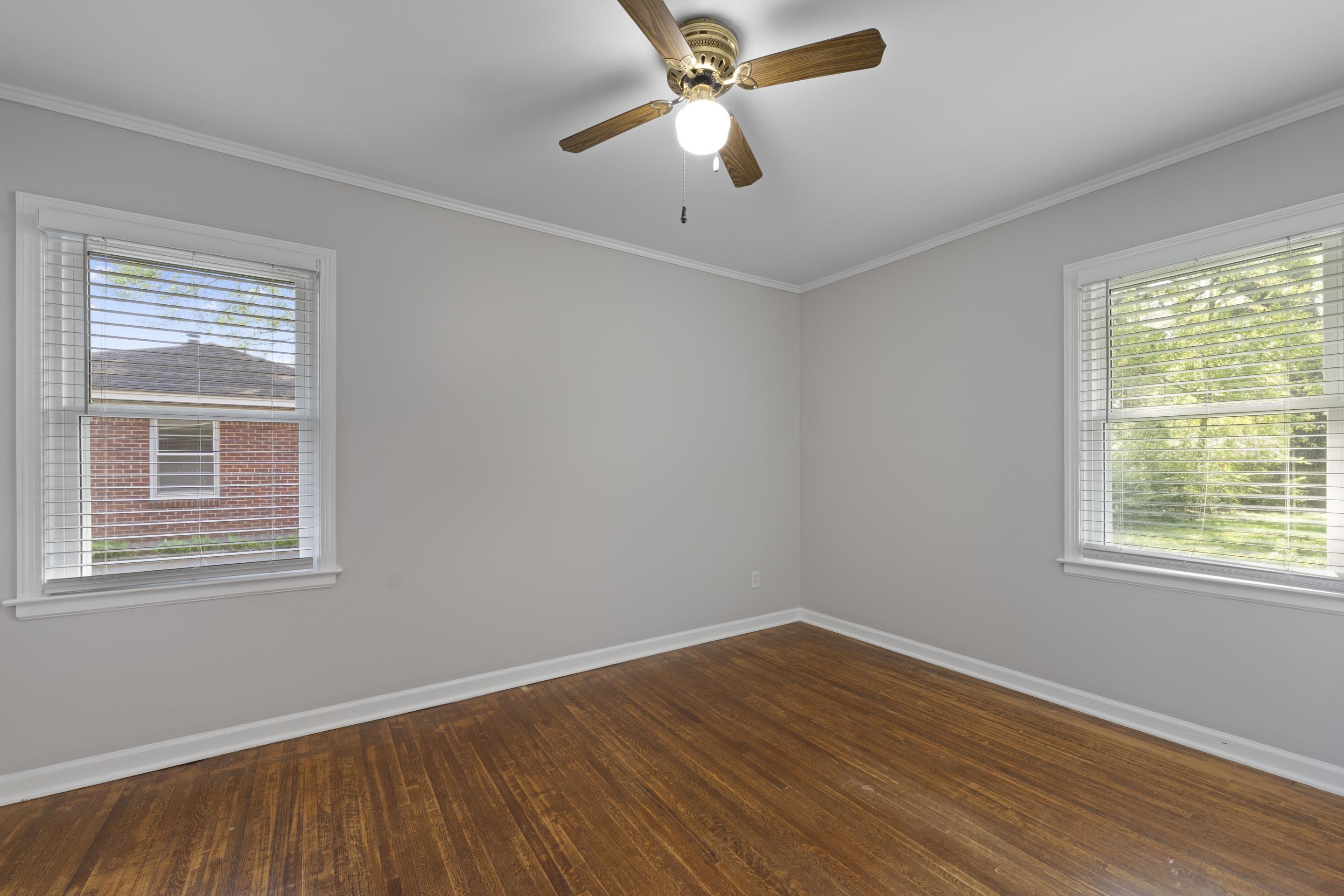 1603 Colonial Road Memphis, TN 38117 - Photo 9 of 24 a view of an empty room with wooden floor and a window